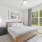 Primary bedroom with ceiling fan, wood inspired flooring, and a king-size bed